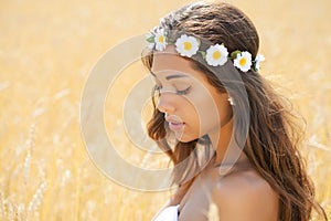 Young woman in a wheat golden field