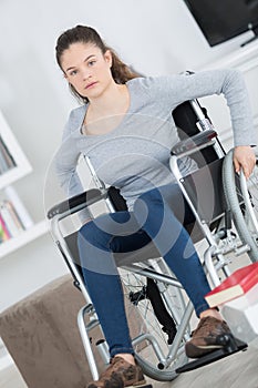 Young woman in wheelchair looking at camera