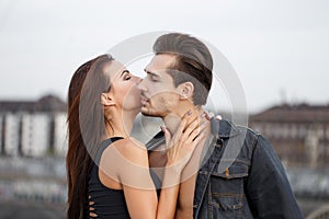 Young woman whispering secret love to man