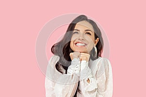 Young woman in a white blouse looking dreamy