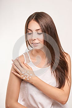 Young woman with white cream. Sun care lotion