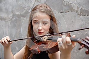 Young woman with white hair and blonde hair playing violin. beautiful musician female performer instrument play music