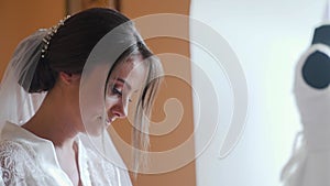 Young woman in white lingerie reading letter indoors and crying