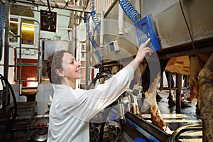 Young woman in white robe operates machine for