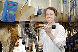 Young woman in white robe shows machine for