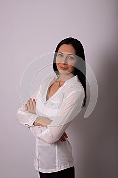 A young woman in a white shirt on white background. Careerist, business portrait