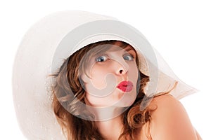 Young woman in white summer hat kissing
