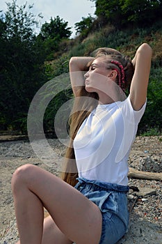 Young woman in white t-shirt relaxing in nature