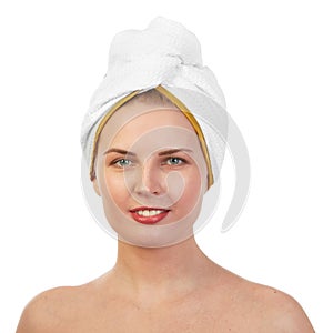 Young woman in white towel wrapped around head