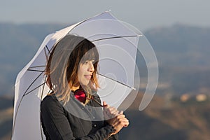 Young woman with white umbrella