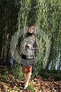 Young woman by willow tree