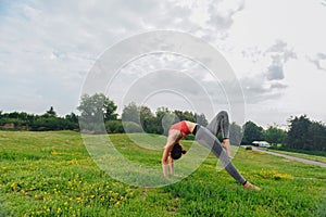Young woman with willowy figure standing in yoga pose