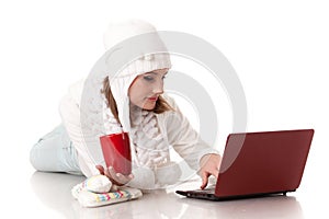 Young woman in winter clothes with laptop.