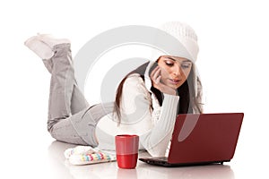 Young woman in winter clothes with laptop