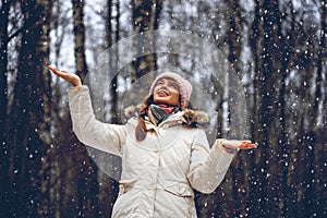 Young woman and flying snowflakes