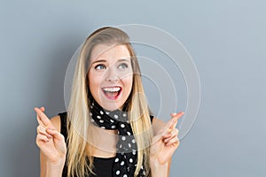 Young woman wishing for good luck