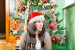 Young woman wondering about Christmas presents and New Year gift
