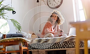 Young woman working in bed at home with laptop