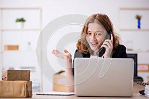 Young woman working in box delivery service