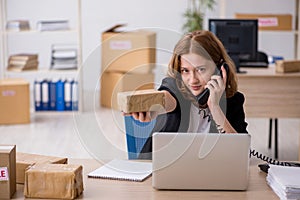 Young woman working in box delivery service