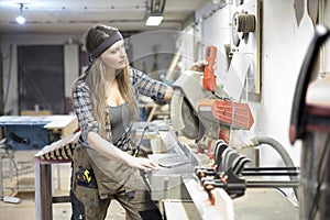 young woman working in carpenter workshop