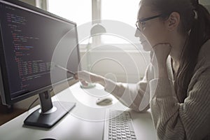 Young woman working on computer from her home