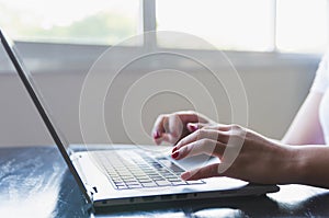 Young woman working on computer at home