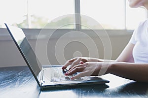 Young woman working on computer at home