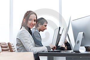Young woman is working on a computer in the office.