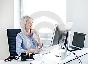 Young woman working on the computer in the office