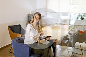 Young woman working with digital tablet in the office