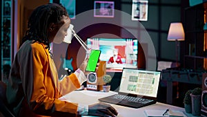 Young woman working with financial spreadsheet and greenscreen