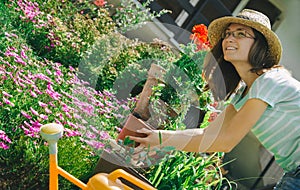 Young woman working in flower garden