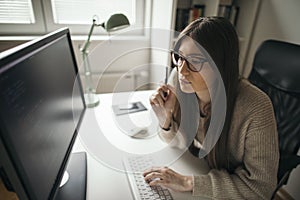 Young woman working at her home office