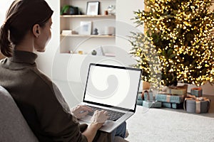 Young woman working at home during Christmas holidays.Virtual event, working from home, ordering Christmas gifts concept