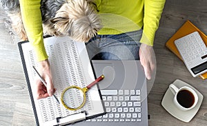 Young woman working at home. She is with her dogs