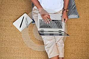 A young woman working on a laptop computer at home. Business con