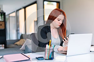 Young woman working on a laptop from home