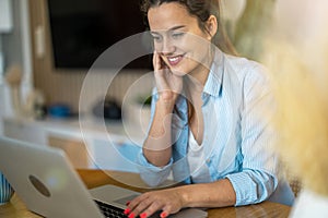 Young woman working on laptop at home