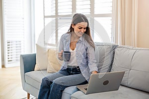 Young woman working on laptop at home