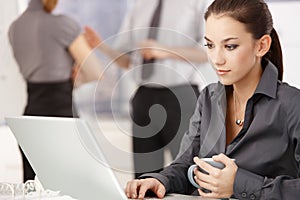 Young woman working on laptop in office
