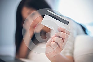 Young woman working on a laptop and uses credit card, bussiness and shopping concept