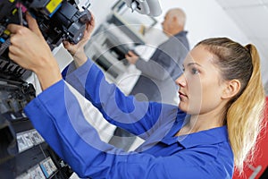 Young woman working in mechanic shop