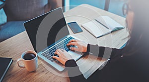 Young woman working at modern office loft.Blurred background.Horizontal Closeup.