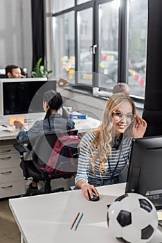 young woman working at modern office and looking