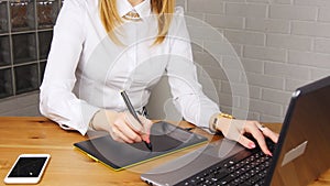 Young woman working in office with graphic tablet