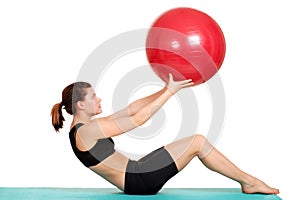 Young woman working out with ball
