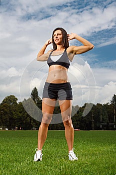 Young woman working out in a park