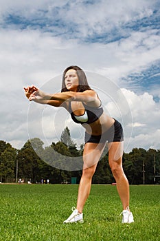 Young woman working out in a park