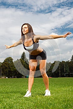 Young woman working out in a park